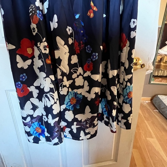 BloomChic ruffled sleeveless navy dress covered in butterflies. Below the knee. - Picture 6 of 7